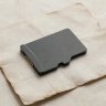 Small 3D render of a microSD card on a parchment background